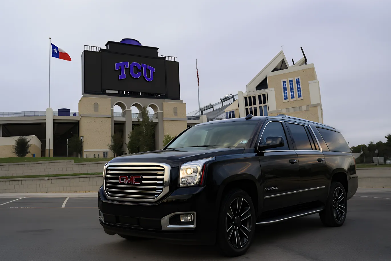 Black executive SUV at Amon G. Carter Stadium for TCU game day VIP drop-off in Fort Worth